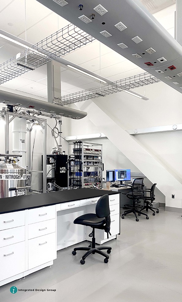 An image of a new lab that has a white workbench and a black office chair