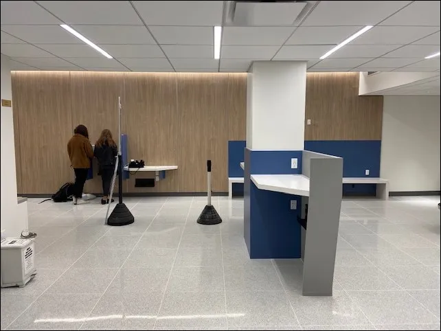 A modern lobby in Kent Hall wooden wall panels and blue and gray accents.