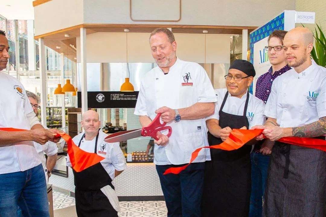 The chefs at Manhattanville Market perform a ribbon cutting inside Manhattanville Market.
